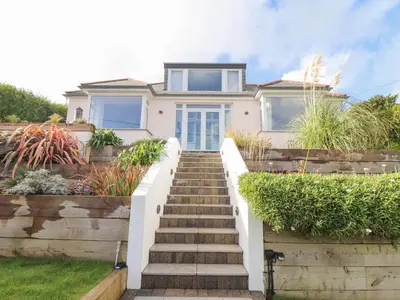 a house with stairs leading up to it at Higher Bolenna in Perranporth