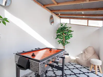 a ping pong table in a living room at Harlequin Cottage in St Austell