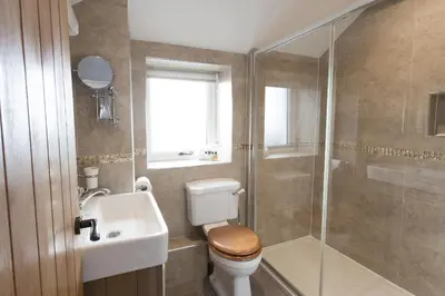 a bathroom with a toilet and a sink and a shower at Cornish Views in Camborne