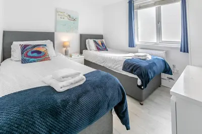 a bedroom with two beds with blue and white sheets at 2 Bed in Newquay oc-a28105 in Newquay