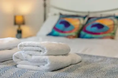 a pile of towels sitting on top of a bed at 2 Bed in Newquay oc-a28105 in Newquay