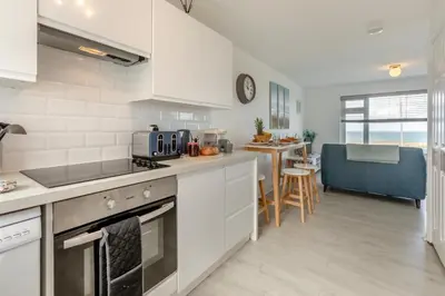 a kitchen with white appliances and a dining room at 2 Bed in Newquay oc-a28105 in Newquay