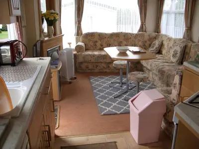 a living room with a couch and a table at Colin and annioes caeravan in Looe