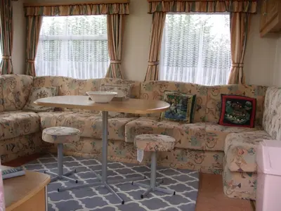 a living room with a couch and a table at Colin and annioes caeravan in Looe