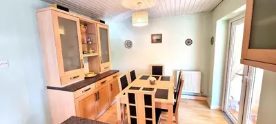 a kitchen with a table and a dining room at Trenare in Perranporth