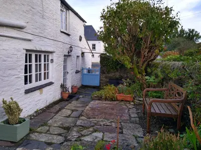 a garden in front of a white house at Lilac Cottage Tintagel in Tintagel