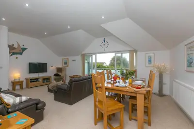 a living room with a table and a couch at Polmoor in St Ives