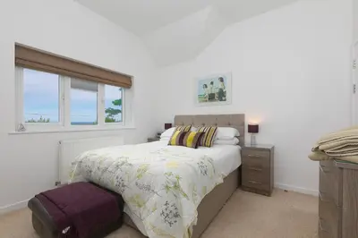 a bedroom with a bed and a window at Polmoor in St Ives
