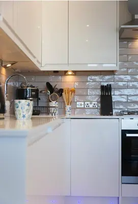 a kitchen with white cabinets and a counter top at Sea Salt sea views parking in St Ives