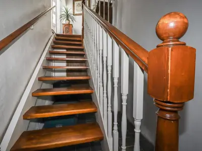 a spiral staircase with wooden railings in a home at Harbour Light in Boscastle