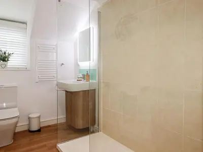a bathroom with a sink and a toilet at Harbour Light in Boscastle