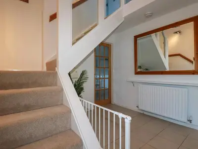 a staircase in a house with a mirror at Seacroft in Newquay