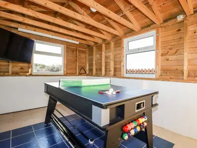 a ping pong table in a room in a house at Seacroft in Newquay