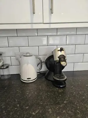 a coffee maker sitting on a counter next to a toaster at Pet Friendly Sea view Villa Millendreath Looe in Looe