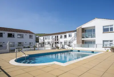 a swimming pool in the middle of a building at 3 Europa Court in Mawgan Porth in Mawgan Porth