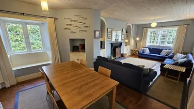 a living room with a table and a couch at Corner Cottage in Saint Mawes
