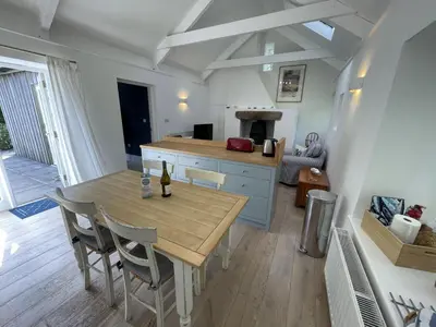 a kitchen and dining room with a table and chairs at Crugsillick Studio in Veryan