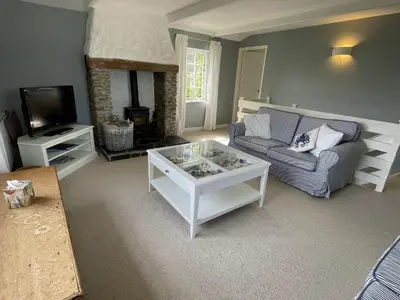 a living room with a couch and a tv at Little Crugsillick in Veryan