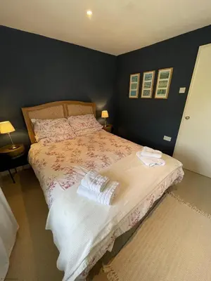 a bedroom with a bed with two towels on it at Little Crugsillick in Veryan