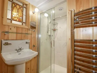 a bathroom with a sink and a shower at Mill Cottage in Liskeard