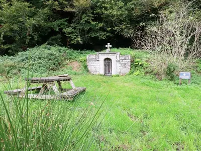 a small stone chapel in a field of grass at Mill Cottage in Liskeard