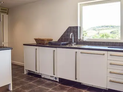 a kitchen with a sink and a window at Top Deck - Cottage in Gorran Haven