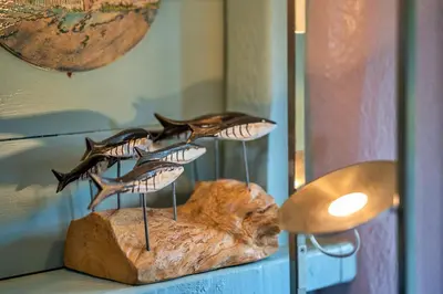 a group of butterflies on a rock in a window at Finest Retreats - Fishermans Cottage in Tintagel