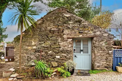 a small stone house with a blue door at Finest Retreats - Fishermans Cottage in Tintagel
