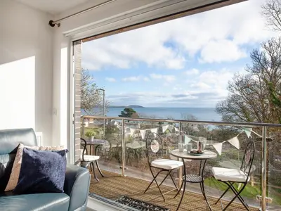 a room with a balcony with a table and chairs at Kamal in Charlestown