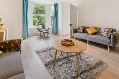 a living room with a couch and a table at Delightful Family Getaway Cornwall in Mawnan Smith