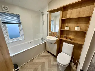 a bathroom with a white toilet and a sink at Luxury 3 bedroom Maple View Lodge, Newquay, Cornwall in Newquay