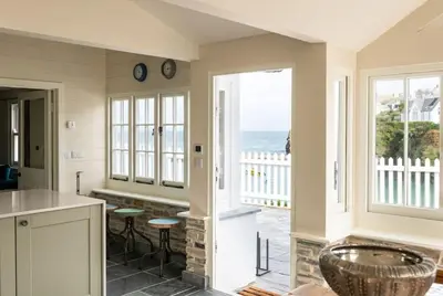 a kitchen with a view of the ocean at White House Cottage, Port Isaac Bay Holidays in Port Isaac