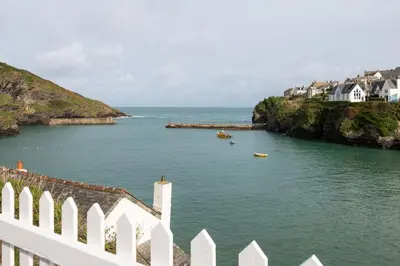 a view of a body of water with boats in it at White House Cottage, Port Isaac Bay Holidays in Port Isaac