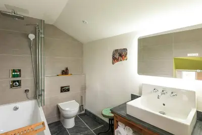 a bathroom with a sink and a toilet and a shower at White House Cottage, Port Isaac Bay Holidays in Port Isaac