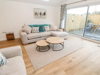a living room with a couch and a table at Puffins Rest in Penzance
