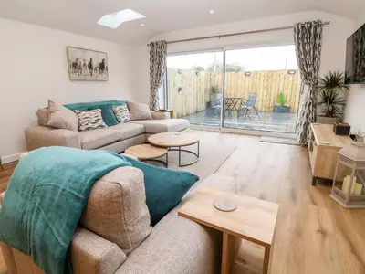 a living room with a couch and a table at Puffins Rest in Penzance
