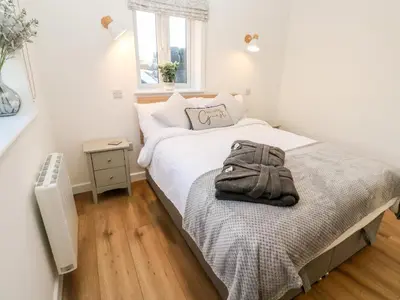 a bedroom with a bed with a towel on it at Puffins Rest in Penzance