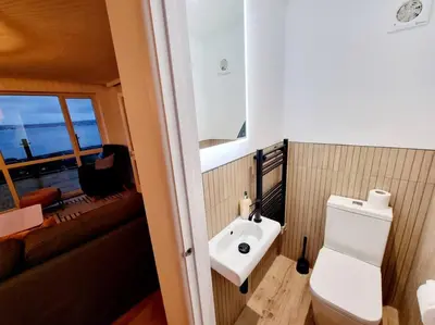 a bathroom with a white toilet and a sink at 1Rosemount -Marazion - Iconic view of St Michaels Mt, Sea, Beach, 2xParking, Netflix Prime in Marazion