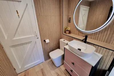 a bathroom with a white sink and a mirror at 1Rosemount -Marazion - Iconic view of St Michaels Mt, Sea, Beach, 2xParking, Netflix Prime in Marazion