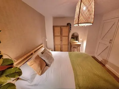 a bedroom with a bed and a chandelier at 1Rosemount -Marazion - Iconic view of St Michaels Mt, Sea, Beach, 2xParking, Netflix Prime in Marazion