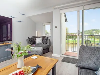 a living room with a couch and a table at 6 Camelside in Wadebridge