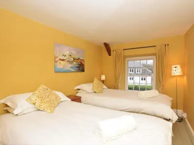 two white beds in a room with a window at 4 Bed in Tintagel oc-tolbo in Tintagel