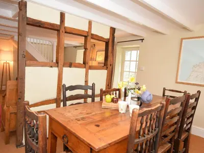 a dining room with a wooden table and chairs at 4 Bed in Tintagel oc-tolbo in Tintagel