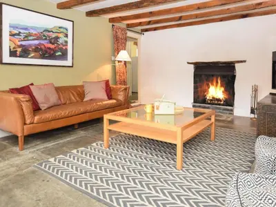 a living room with a couch and a fireplace at 4 Bed in Tintagel oc-tolbo in Tintagel