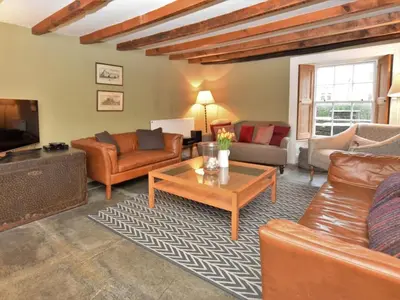 a living room with leather furniture and a coffee table at 4 Bed in Tintagel oc-tolbo in Tintagel