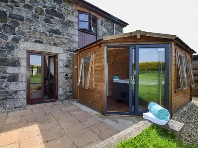 a wooden garden room with sliding glass doors at 3 Bed in Helston oc-htfox in Saint Martin