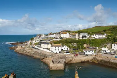 a group of houses on a hill next to the ocean at Chy Lowen in Helston