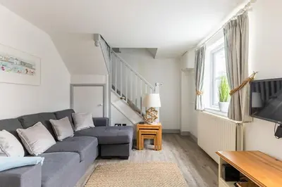 a living room with a couch and a tv at Stunning cosy cottage in old town Padstow sleeps 4 in Padstow