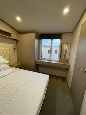 a small bedroom with a bed and a window at Two bedroom Holiday home in Newquay
