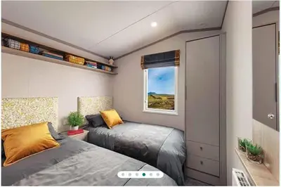 a small bedroom with a bed and a window at Two bedroom Holiday home in Newquay